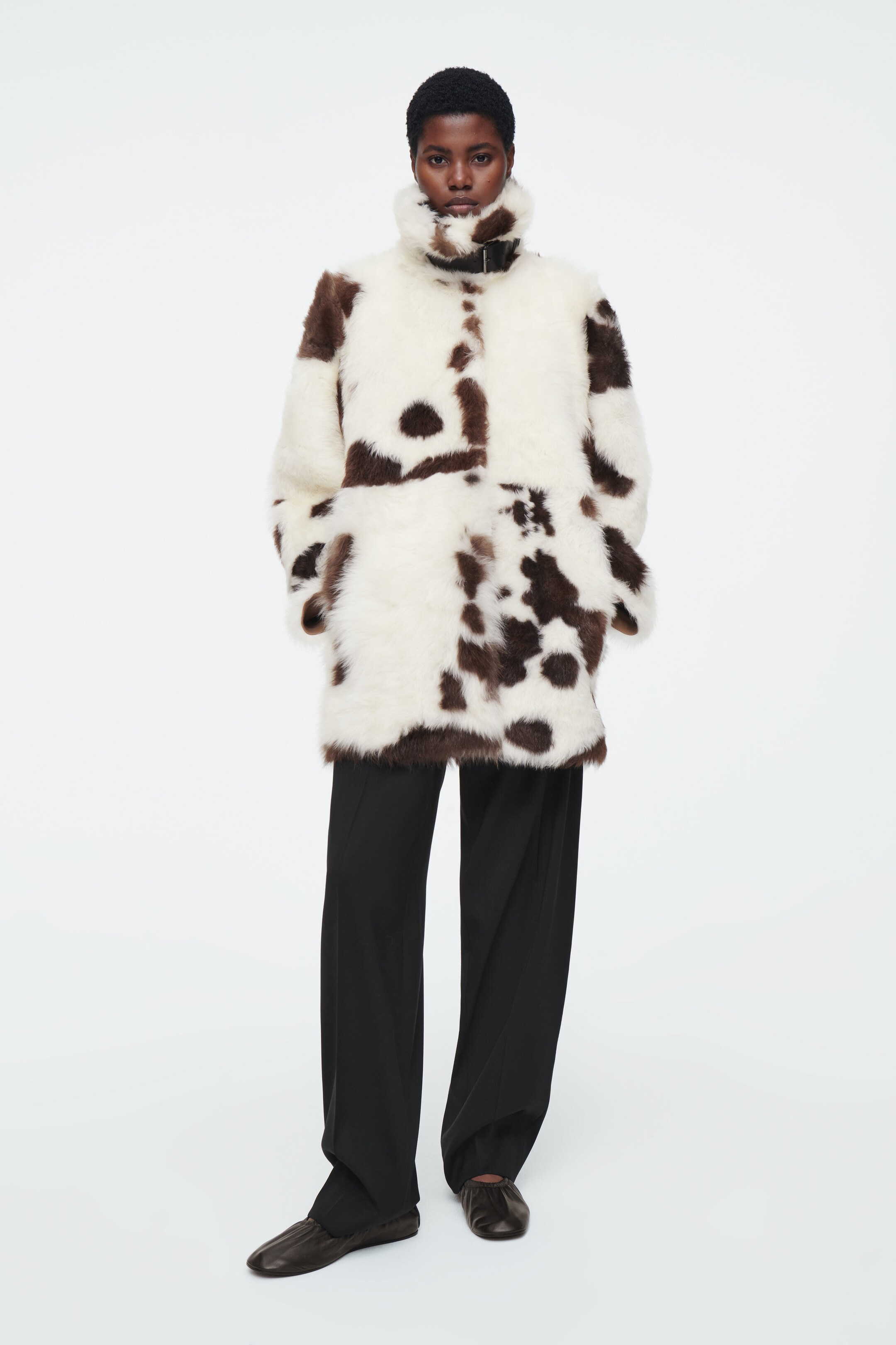 THE FUNNEL-NECK SHEARLING COAT