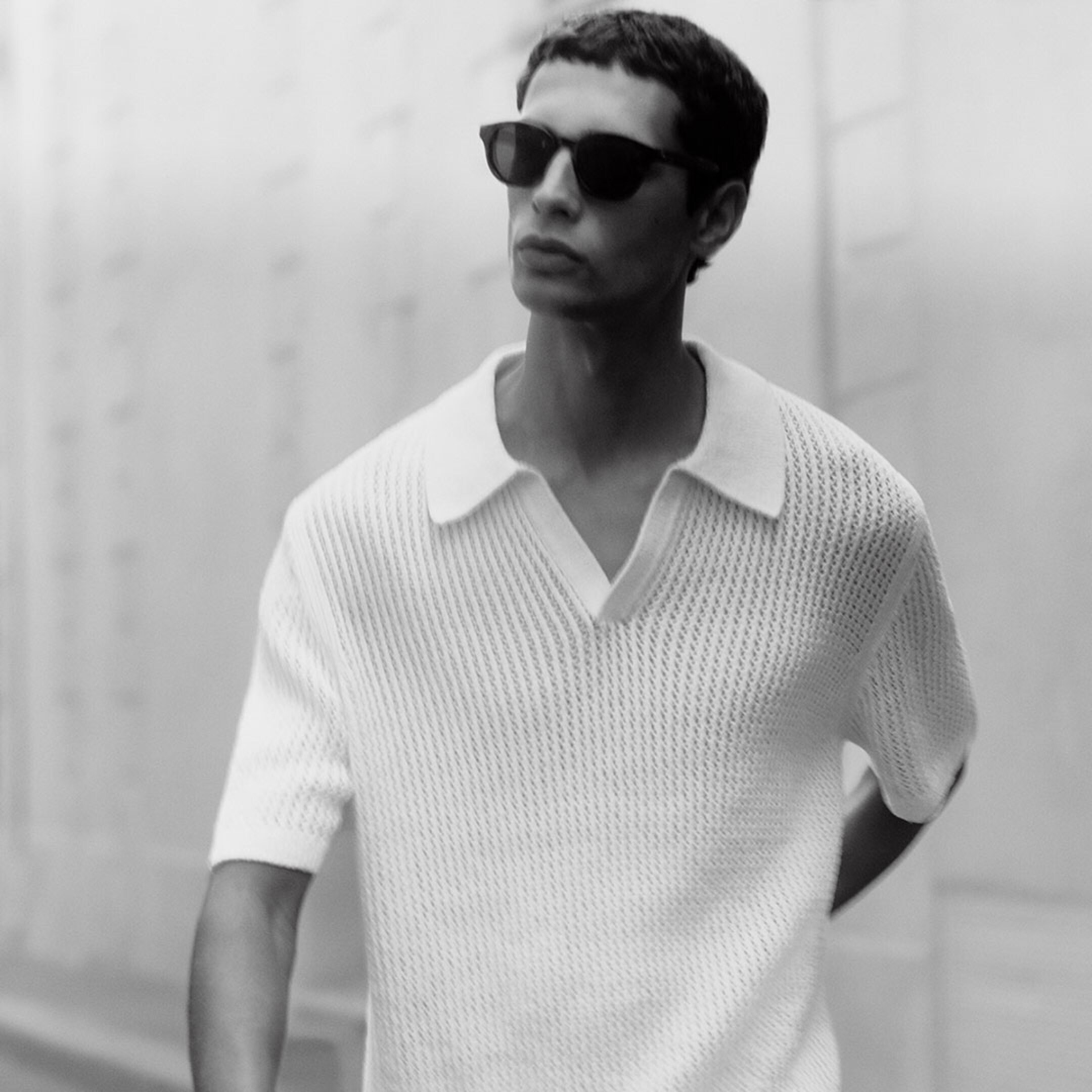 man in white knit polo