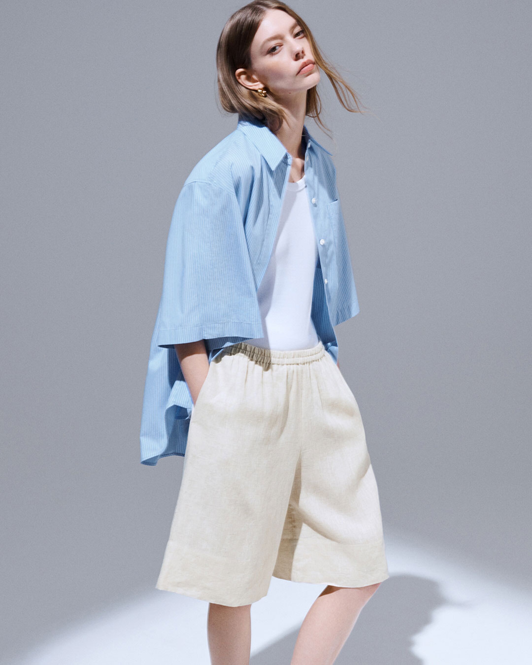 woman in stripe shirt and linen shorts