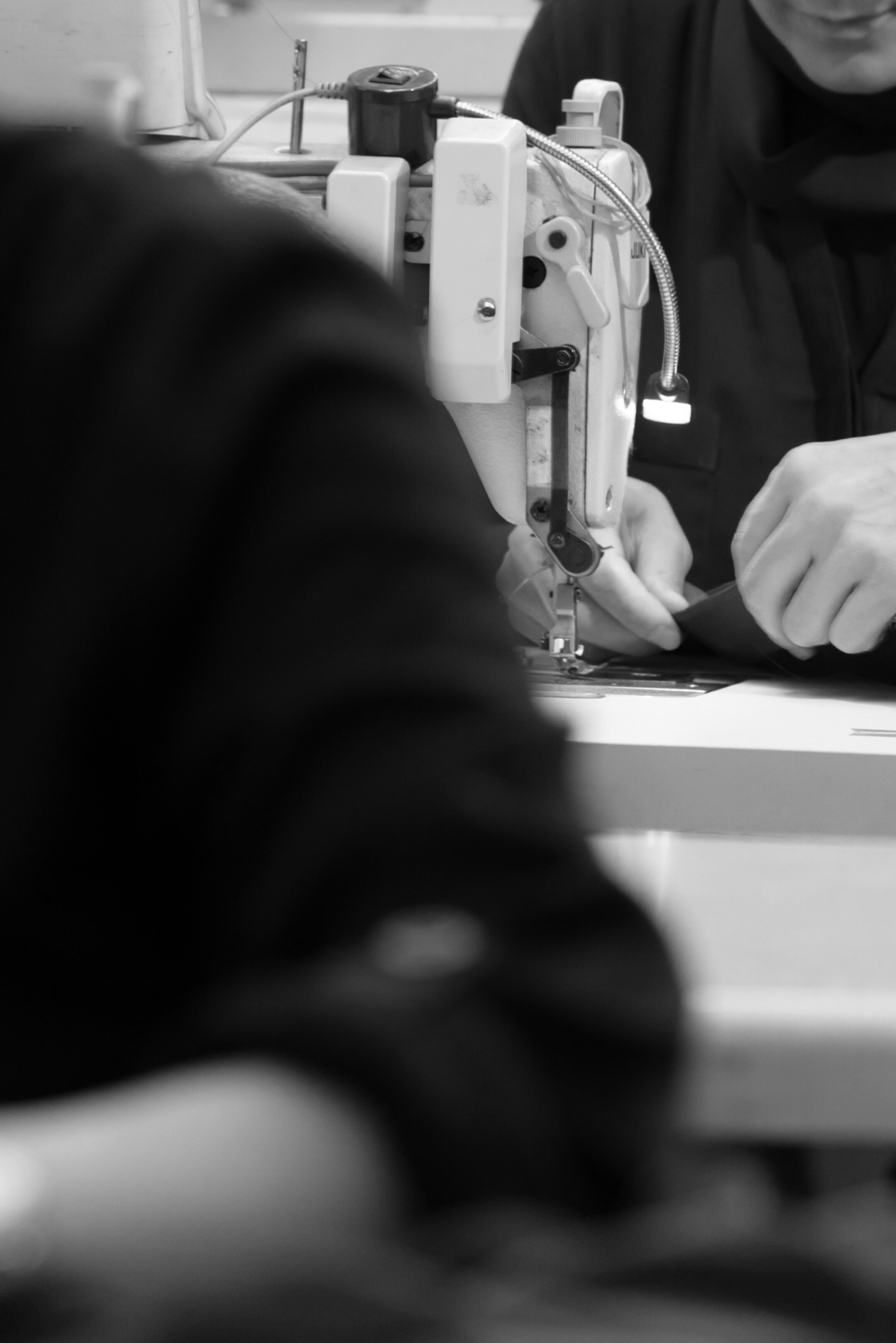 Zoomed in picture of person using sewing machine