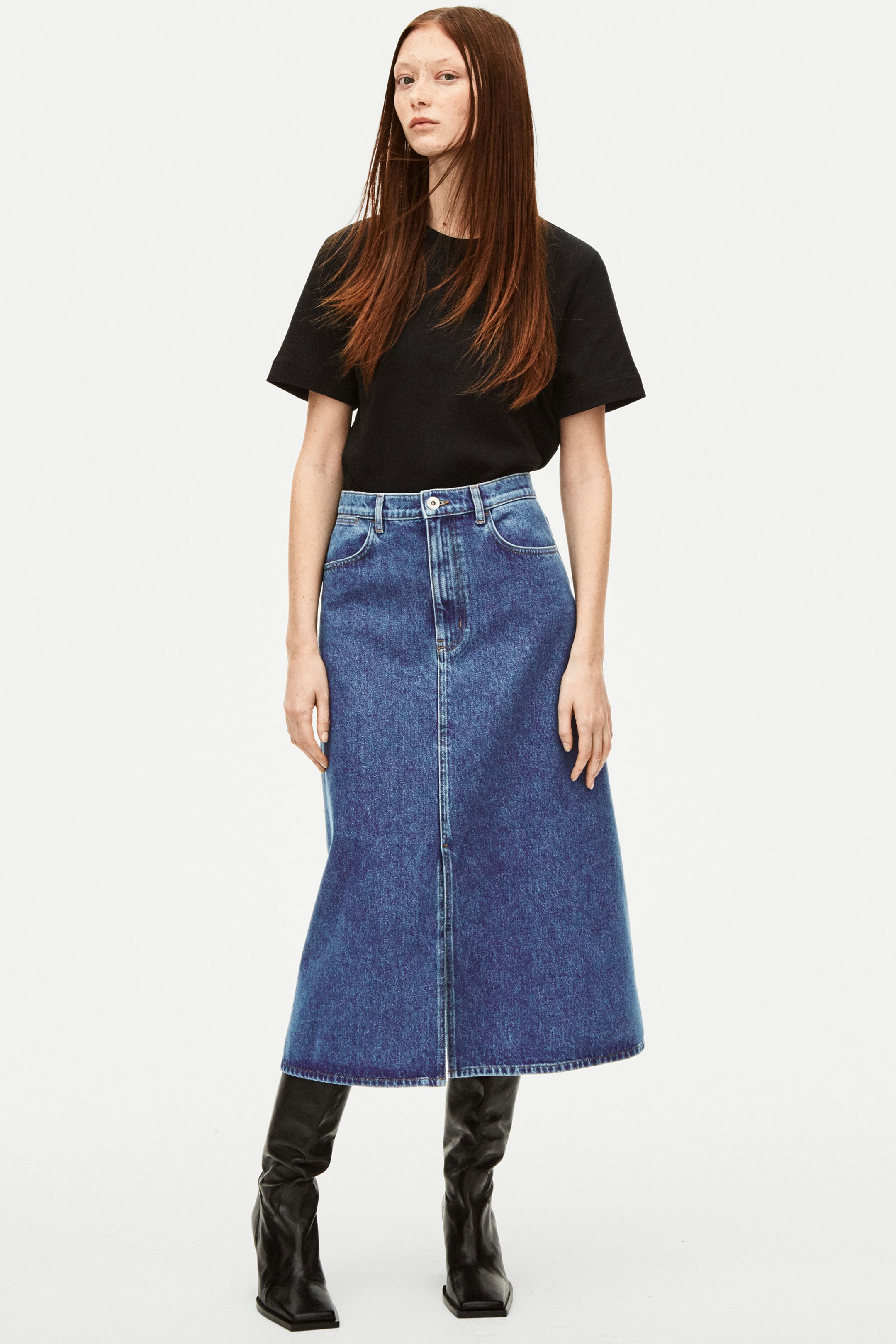 Woman wearing black tshirt with midi denim skirt