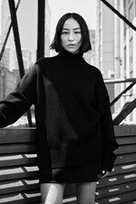 Placeholder for: Greta Lee wearing COS black jumper and COS black skirt