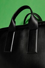 Placeholder for: Up close shot of cactus leather black bag handle