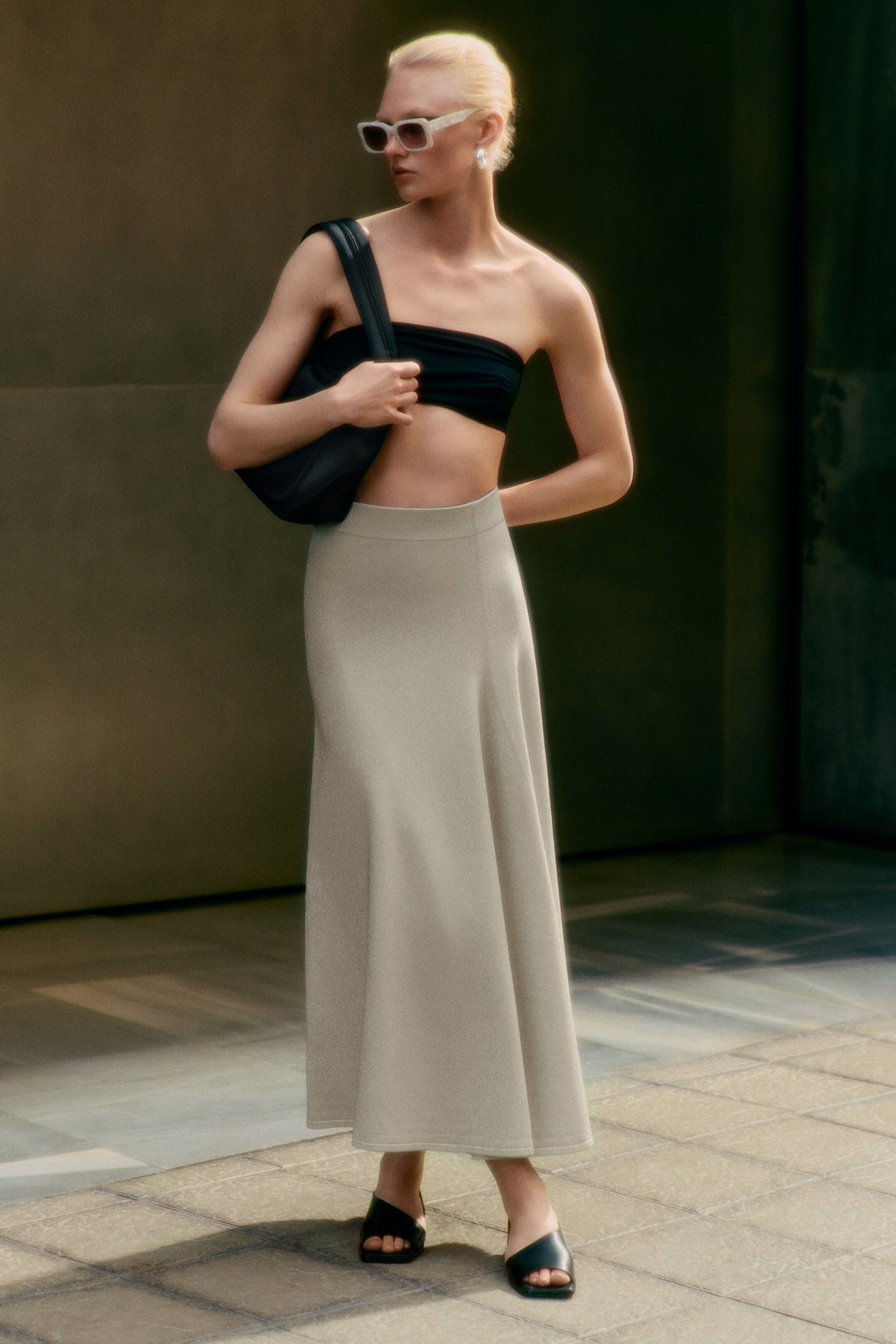 Woman wearing black bandeau and maxi knitted skirt