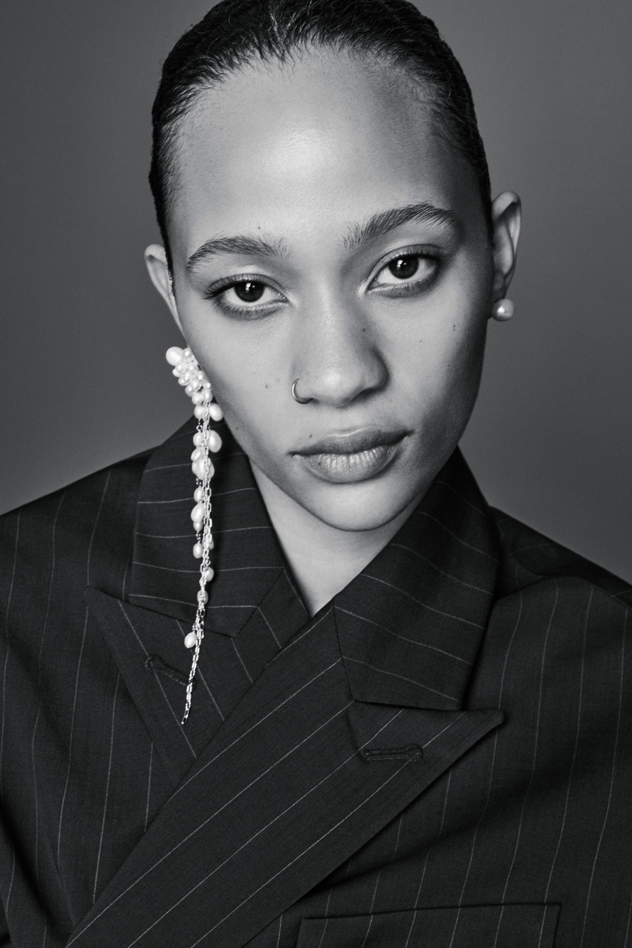 Model wearing COS earrings and blazer