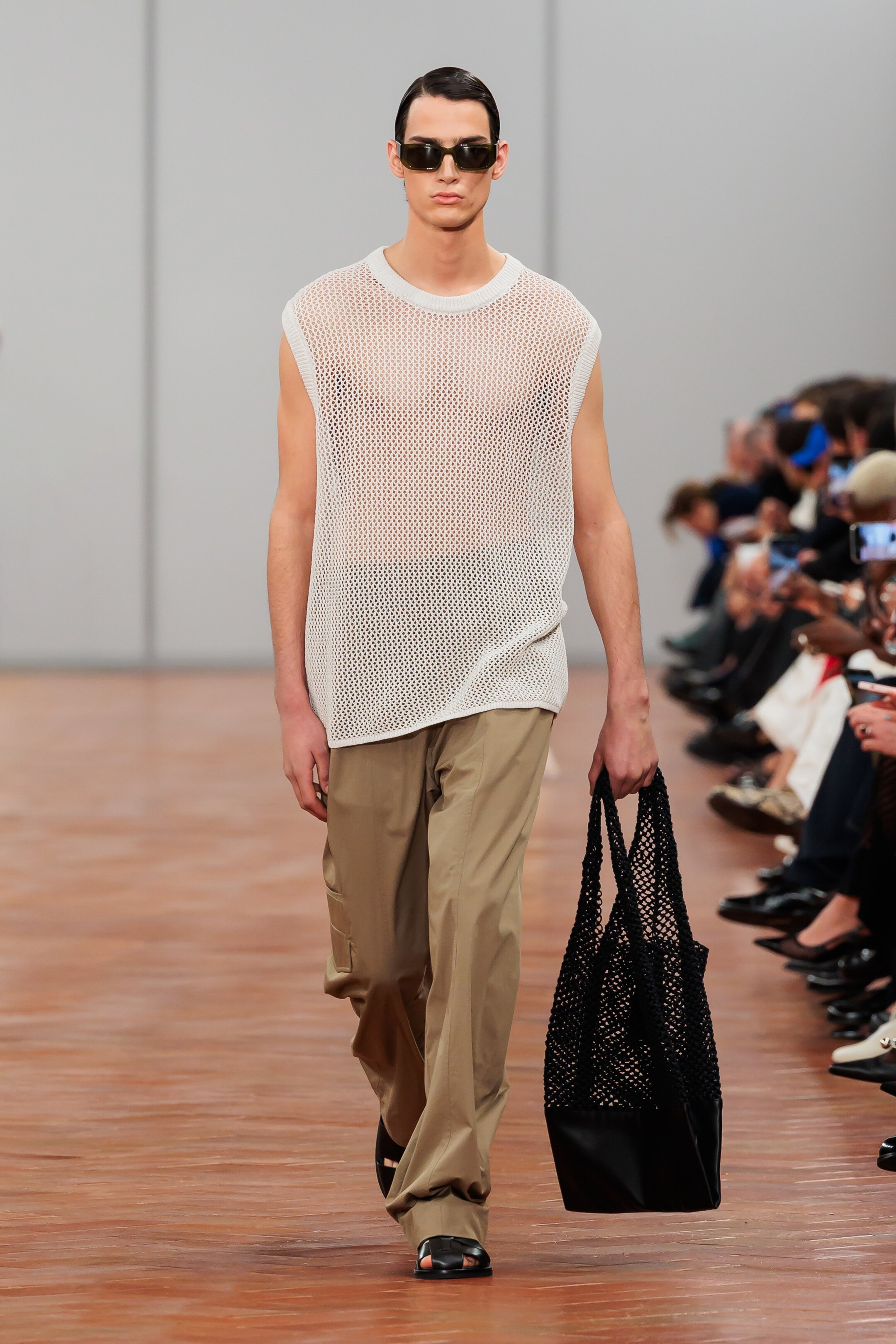 man wearing fishnet tank and cargo pants