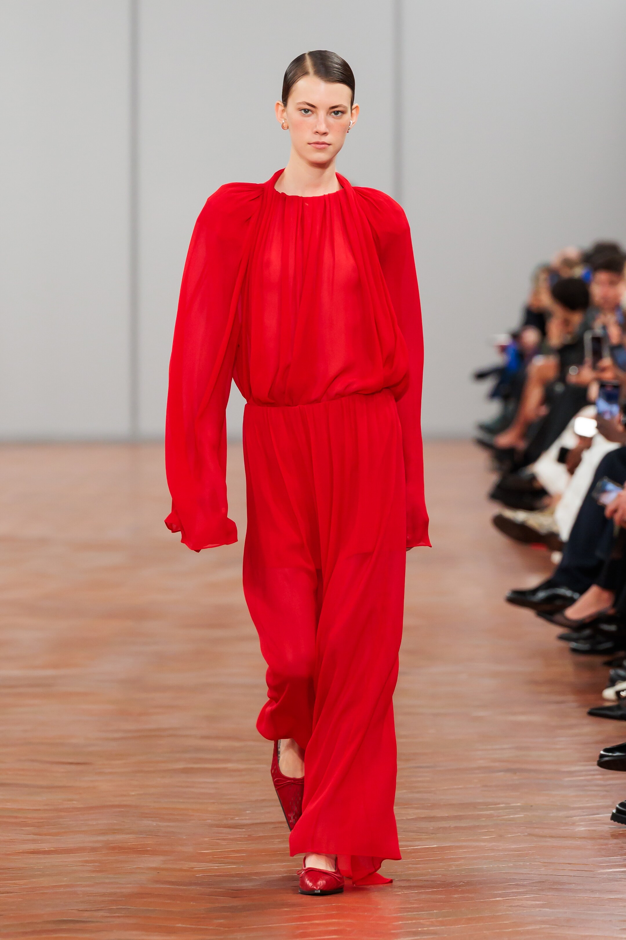 woman wearing red pleated blouse and skirt