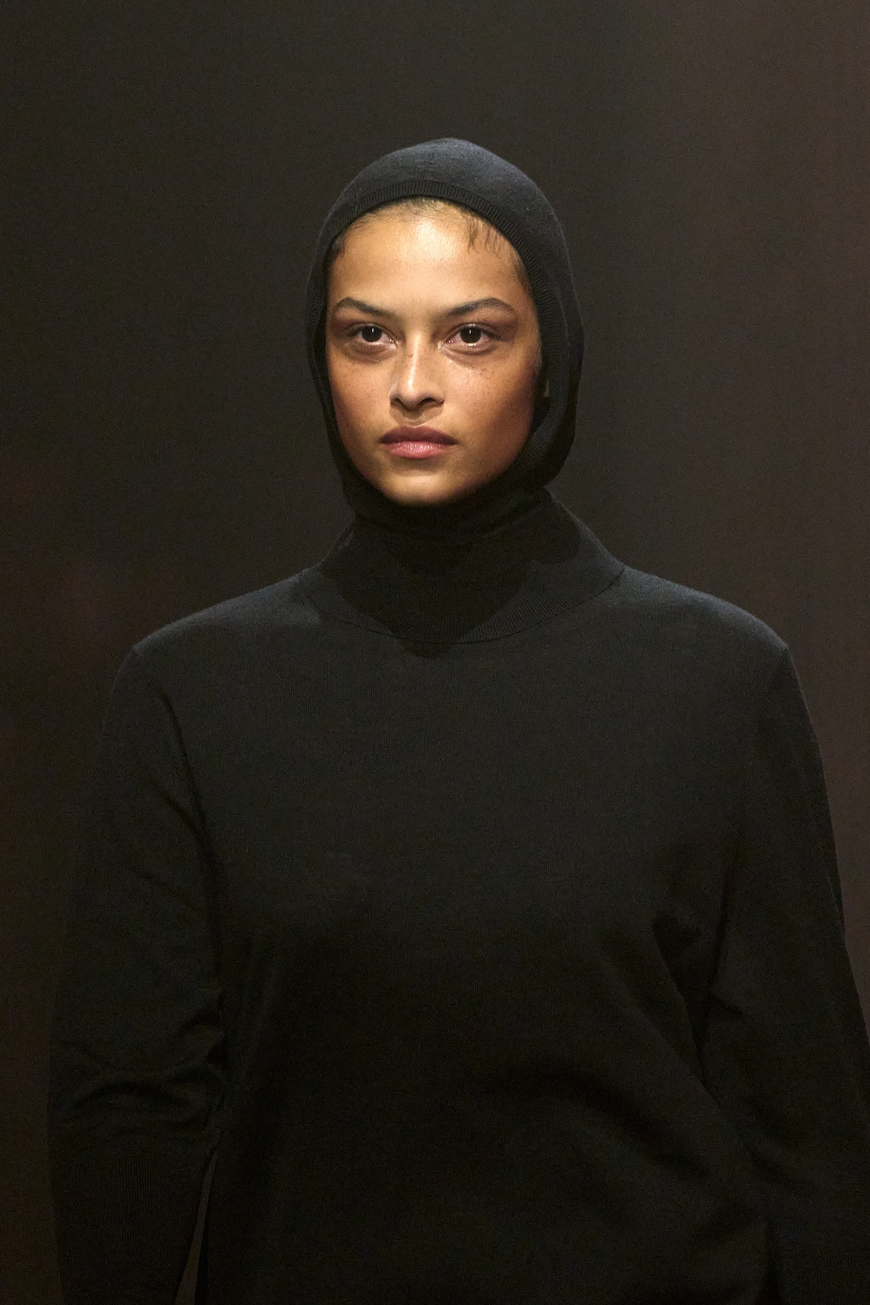 Model wears black balaclava and black top