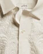 Placeholder for: Close up of cream broiderie white blouse