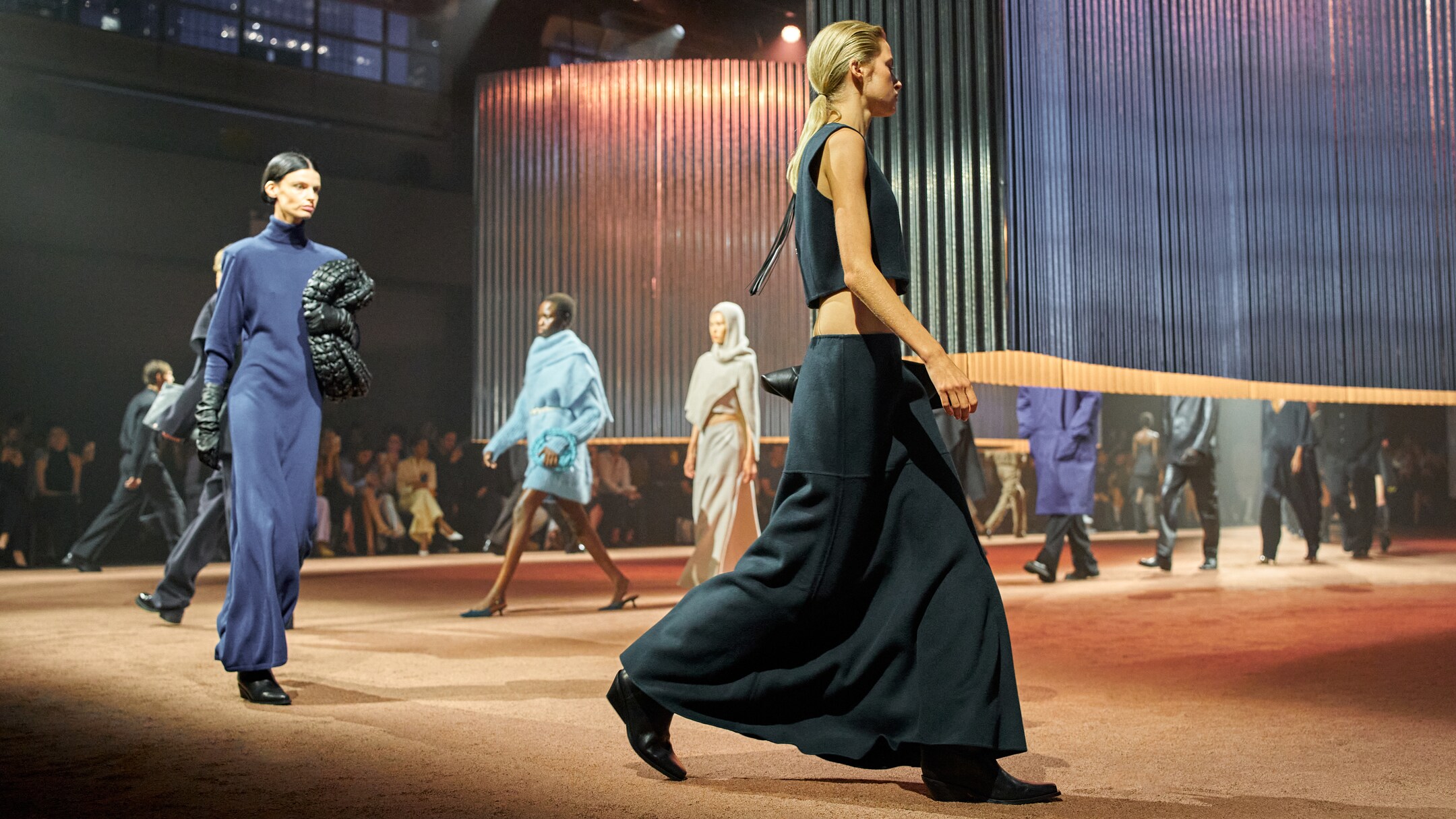 Model walks runway wear black cropped top and black maxi skirt