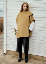 Placeholder for: Woman wearing beige poncho