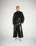 Placeholder for: Woman in full leather matching jacket & short trousers with fluffy shoes