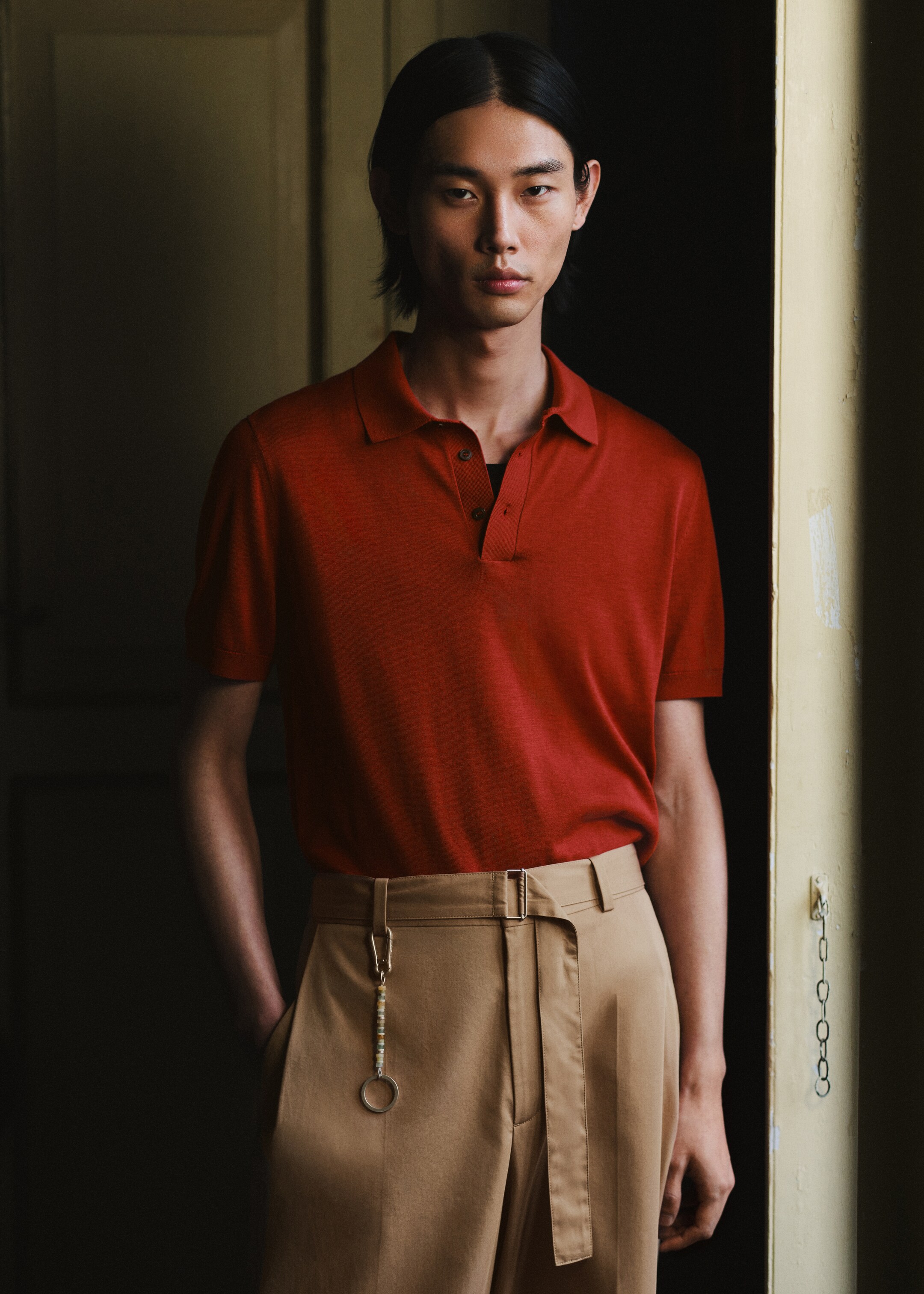 model wearing red polo shirt