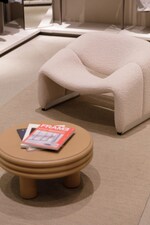 Placeholder for: COS store showing recycled rug with a white chair and brown table