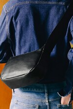 Placeholder for: person holding crossbody leather bag