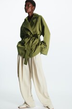 Placeholder for: Woman wearing green trench tied across the waist